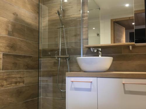 a bathroom with a sink and a glass shower at Appartement Les Arcs 1800, 2 pièces, 5 personnes - FR-1-346-419 in Arc 1800