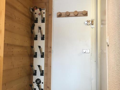 a wall of wine bottles in a room next to a door at Appartement Les Arcs 1800, 2 pièces, 5 personnes - FR-1-346-419 in Arc 1800