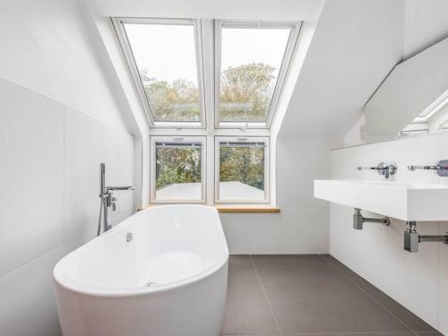 a bathroom with a white toilet and a sink at Luxury West Sussex Seaside Family Retreat in Bognor Regis