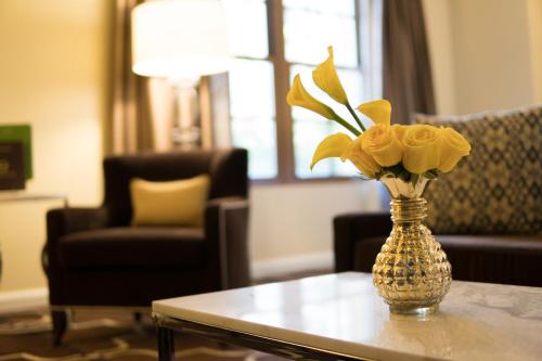 a vase with yellow flowers sitting on a table at Green Valley Ranch Resort Spa Casino in Las Vegas