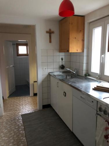 a kitchen with a sink and a cross on the wall at Chalet Crans-Montana in Crans-Montana