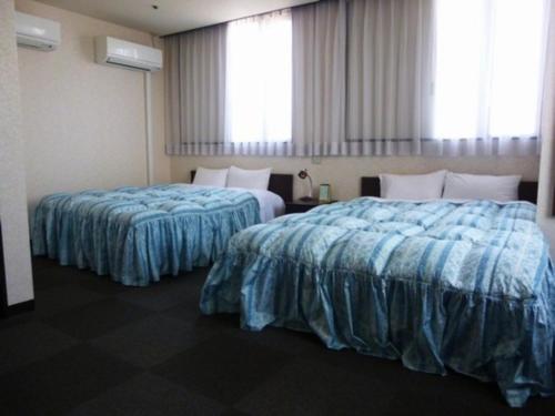 a hotel room with two beds with blue sheets at Hotel Wakow - Vacation STAY 22138v in Yonago