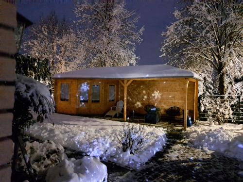 a cabin in the snow at night at 3-Zimmer Ferienwohnung Biggesee Sauerland nahe Olpe in zentraler, ruhiger Lage in Drolshagen