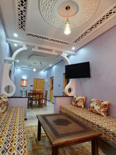a living room with a couch and a table at Residence Adnan luxury Appartments in Ouarzazate