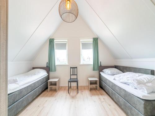 a room with two beds in a attic at Modern holiday home in Scherpenisse with garden in Scherpenisse