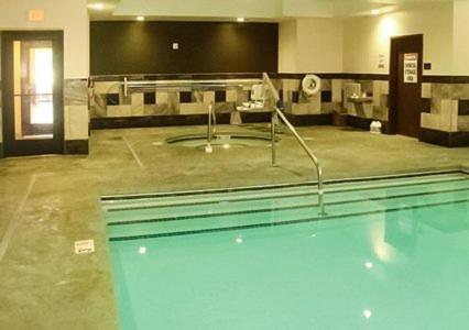 an empty swimming pool in a large room with at Comfort Inn & Suites Woodward in Woodward