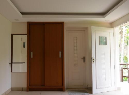 a hallway with a door and a window at Royad Calicut Farm House - Premium Villa with Pool Inside a Farm in Kozhikode