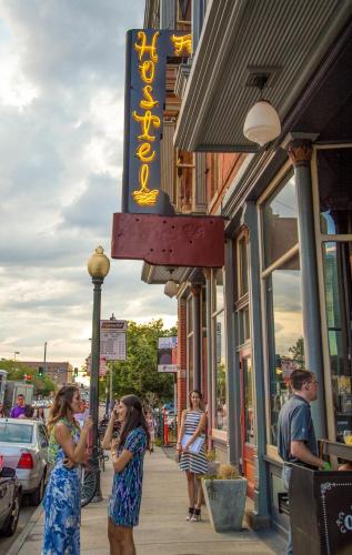 a group of people standing on a sidewalk outside a store at Hostel Fish in Denver