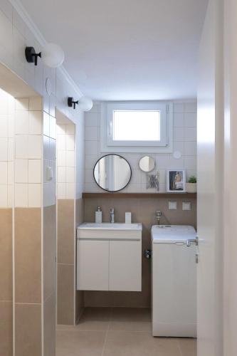 a bathroom with a sink and a mirror at Garden House Retreat in Drama