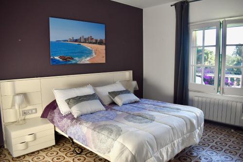 a bedroom with a bed and a view of a beach at La Casa Celestial in Platja d'Aro