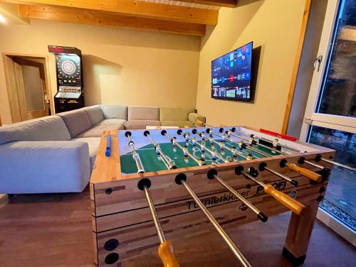 a living room with a large foosball table at Suite zwischen den Wehlen in Westerdeichstrich