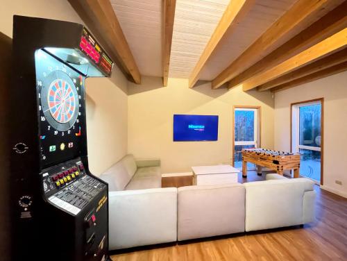 a living room with a dart board and a game console at Suite zwischen den Wehlen in Westerdeichstrich