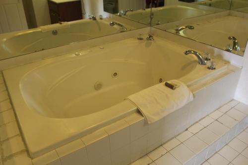 a bath tub in a bathroom with a towel on it at Deerfield Inn in Adamsville