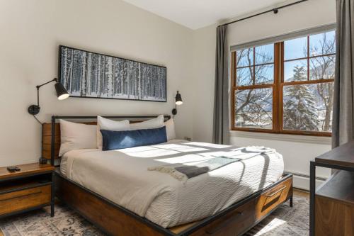 a bedroom with a large bed and a window at Lodge at Brookside 202 in Avon