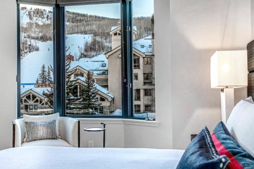 a bedroom with a large window with a mountain view at Beaver Creek Lodge 511 in Beaver Creek