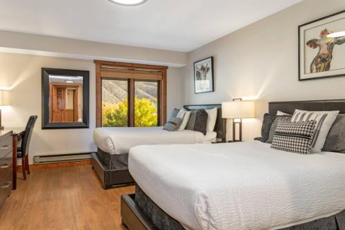 a bedroom with two beds and a window at Lodge at 100 W Beaver Creek Blvd #2 - 401 in Avon