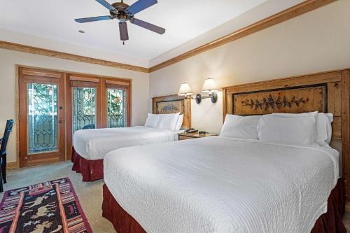 a hotel room with two beds and a ceiling fan at Charter at Beaver Creek E125 studio in Beaver Creek