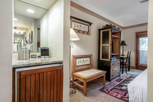 a kitchen with a sink and a desk in a room at Charter at Beaver Creek E125 studio in Beaver Creek