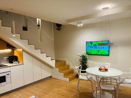 a living room with a table and a staircase at Casa Torre Hacho in Antequera
