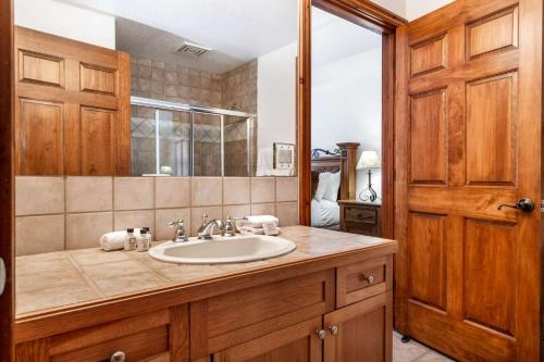 ein Bad mit einem Waschbecken und einem Spiegel in der Unterkunft Lodge at Brookside 106 in Avon