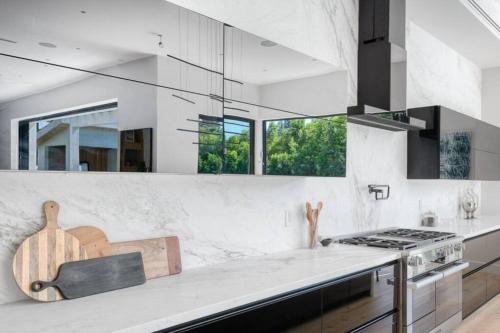 a kitchen with white walls and a stove top oven at ৎ୭ Hollywood Sign View Manor Lux ৎ୭ in Los Angeles