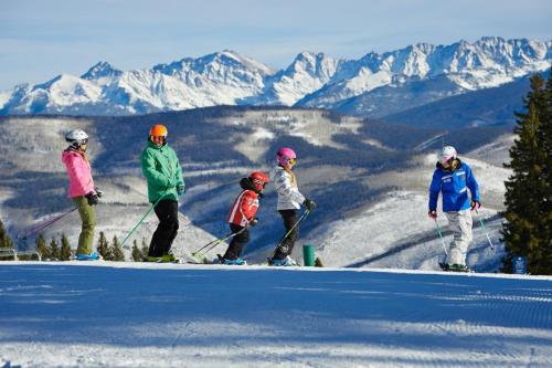 a group of people standing on top of a ski slope at Beaver Creek Lodge 411 in Beaver Creek