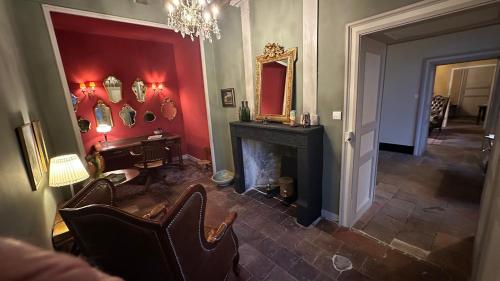 a living room with a fireplace and a mirror at ZONE BLEUE in Hyds