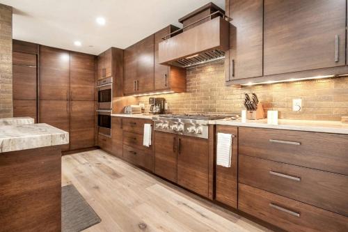 a kitchen with wooden cabinets and a counter top at Beaver Creek Lodge 510 in Beaver Creek