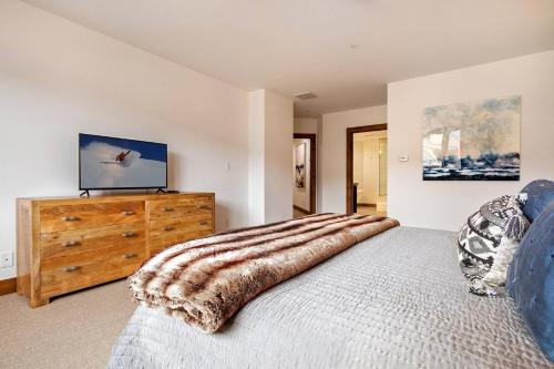 a bedroom with a bed and a wooden dresser at Beaver Creek Lodge 510 in Beaver Creek