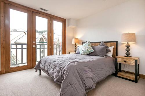 a bedroom with a bed and a large window at Beaver Creek Lodge 510 in Beaver Creek