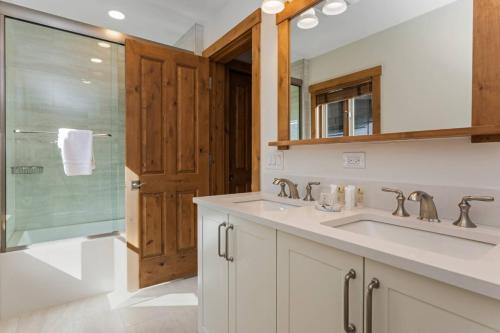 baño con 2 lavabos y ducha de cristal en Villa Montane #212 en Beaver Creek