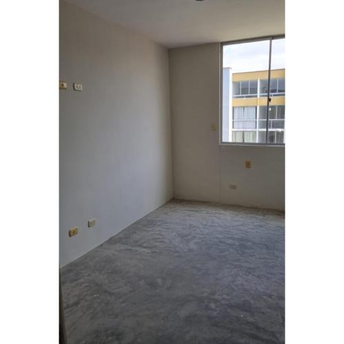 an empty room with a window in a building at Alquiler de habitación in Piura