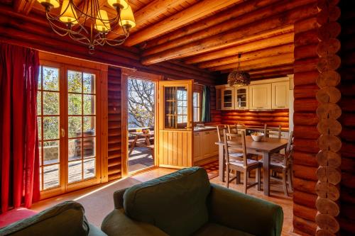 a living room with a couch and a dining room at Paradise Chalet in Ano Trikala
