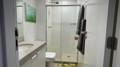 ein weißes Bad mit einer Dusche und einem WC in der Unterkunft Apartamento comfortável, ótima localização in Recife