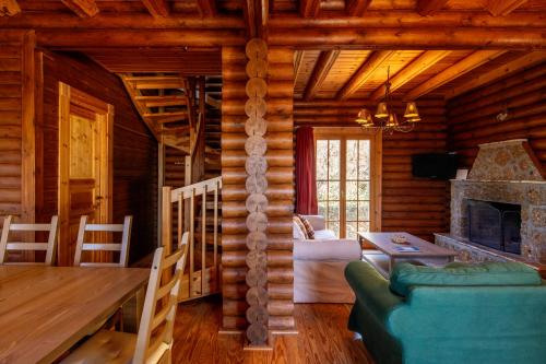 a living room with a fireplace in a log cabin at Paradise Chalet in Ano Trikala