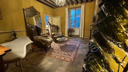 a living room with chairs and a table and a mirror at ZONE BLEUE in Hyds
