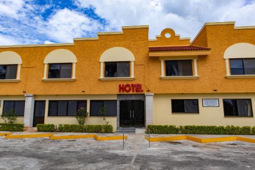 a large orange building with a hotel at Hotel y Villas Costa del Sol in Mérida