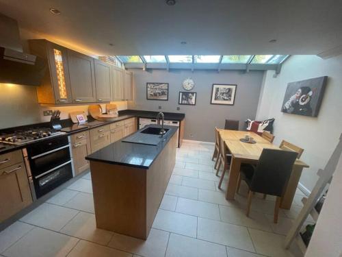 a kitchen with a table and a dining room at Kew Gardens Village in Kew