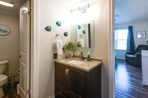 a bathroom with a sink and a toilet at Bayfront Texas Escape with Balcony and Pool Access! in Rockport