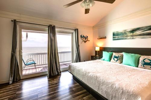 a bedroom with a bed with a view of the ocean at Bayfront Texas Escape with Balcony and Pool Access! in Rockport