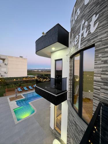 a house with a view of a swimming pool at Villa Shefit in Rrushkull