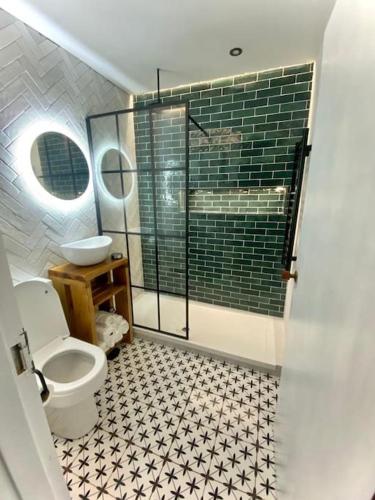 a bathroom with a shower and a toilet and a sink at Pretty fancy staycation - South East London / Kent in Bromley