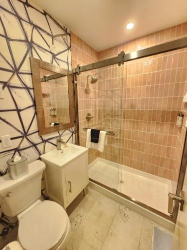 a bathroom with a toilet and a shower and a sink at The Mayfair Hotel Times Square, an Ascend Collection in New York