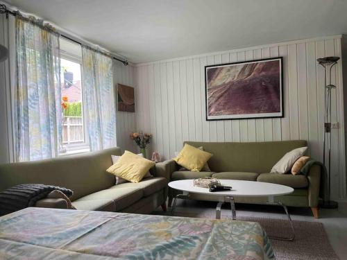 a living room with a couch and a table at Holiday Appartement in Brevik in Porsgrunn