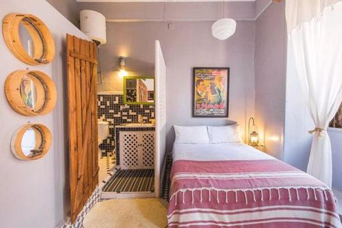 a bedroom with a bed and a bathroom at MED APPARTEMENT in Essaouira