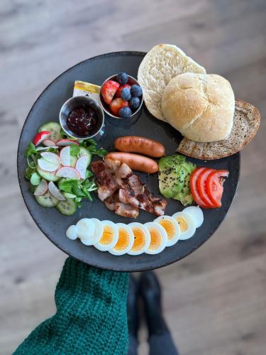a person holding a plate with a plate of food at Hotel Cafe SokoLOVE in Sokolov