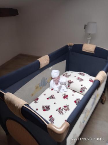 a baby crib with a teddy bear in it at La dimora di Sandy in Viterbo