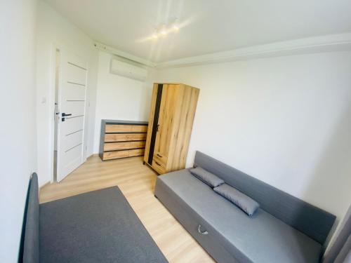 a living room with a couch and a door at Apartament Świdnik in Świdnik