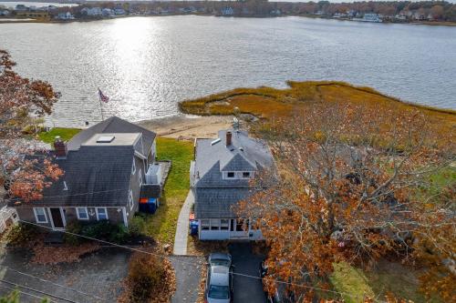 an aerial view of two houses next to the water at 154 Pinehurst Dr, Wareham in Wareham