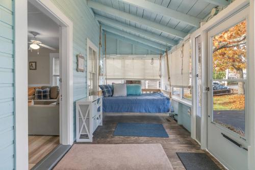 a bedroom in a tiny house with a bed at Pinehurst Sunset Beach Cottage in Wareham